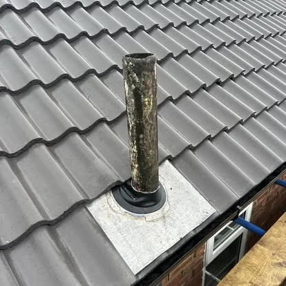 New roof installation project in Merseyside showing completed tiled roof with new ridge tiles