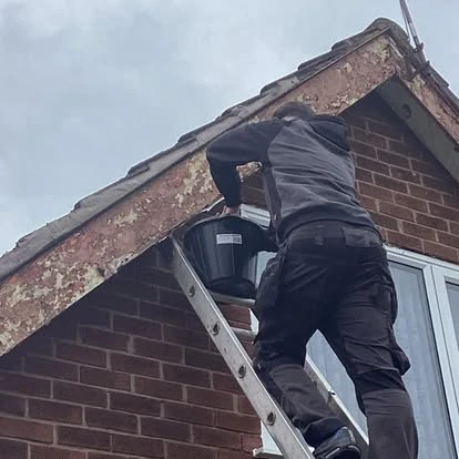Roof repair work showing damaged tiles replaced and secured in Merseyside